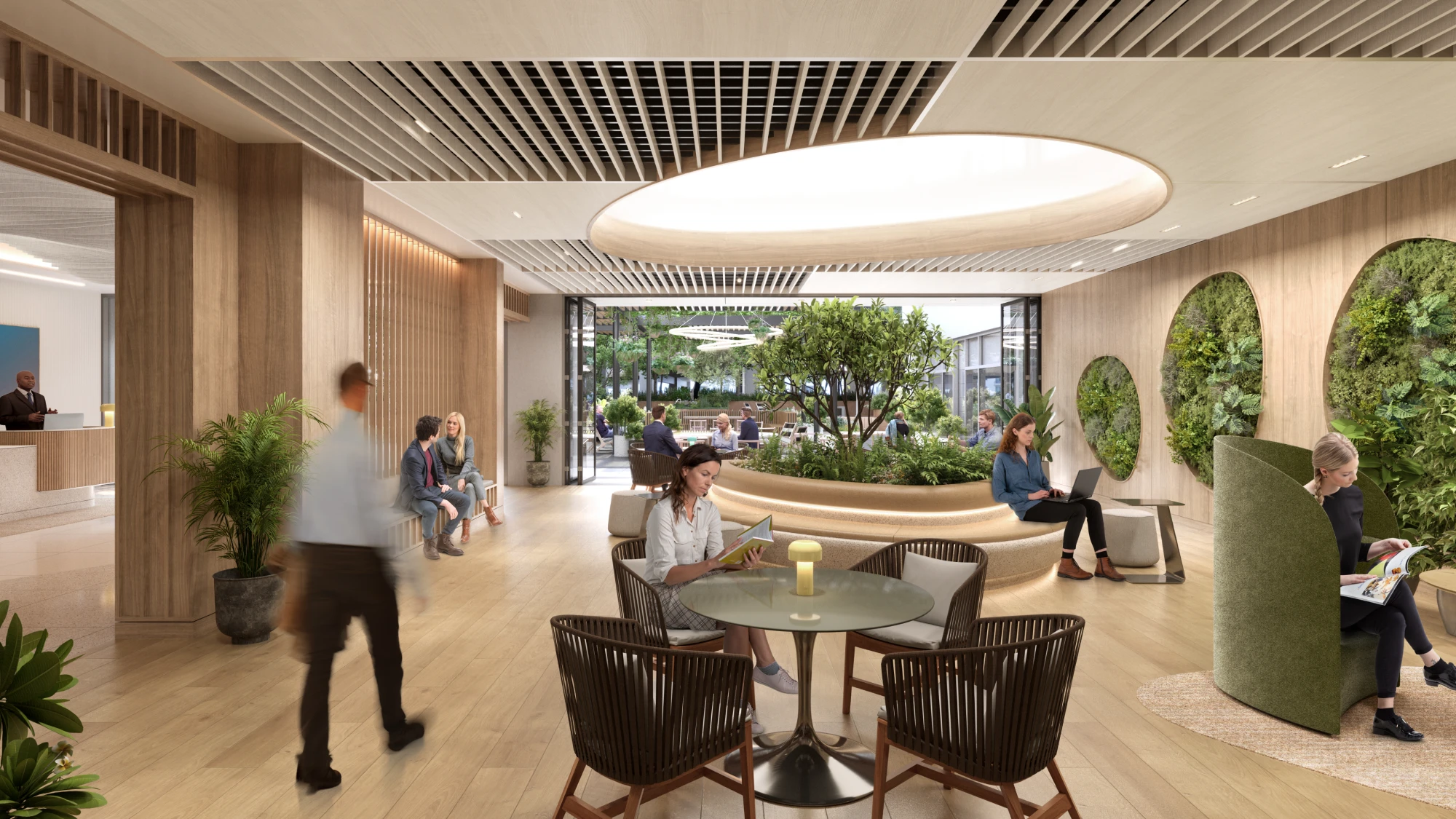 Open-concept workspace with modern furniture, natural lighting, and indoor greenery